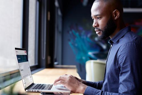 Laptop user browsing YMC campus